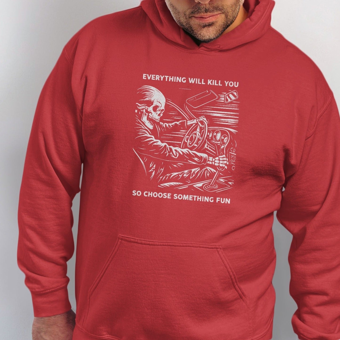 Red hoodie with skeleton driving and text "EVERYTHING WILL KILL YOU SO CHOOSE SOMETHING FUN."