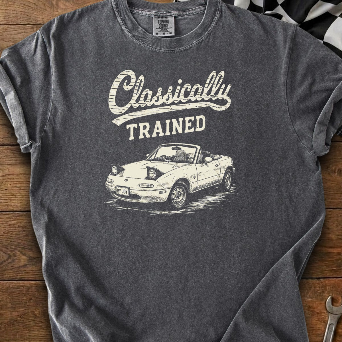 T-shirt with white graphic of a convertible car and text "Classically TRAINED".