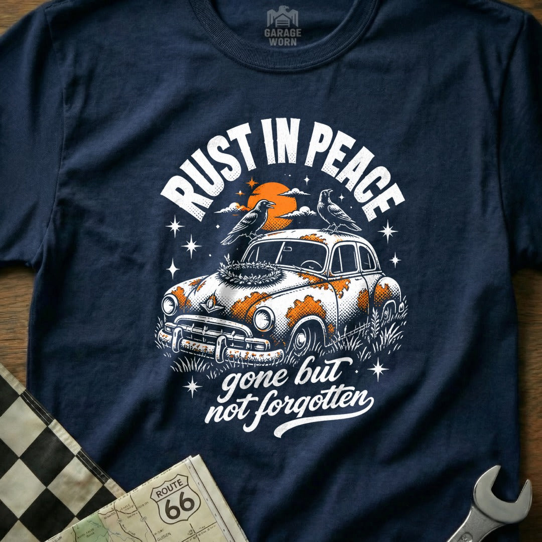 Navy t-shirt graphic with vintage car, birds, and "Rust in Peace" text.