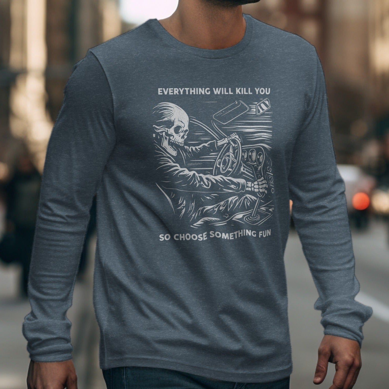 Long sleeve shirt with skeleton driving graphic and text.
