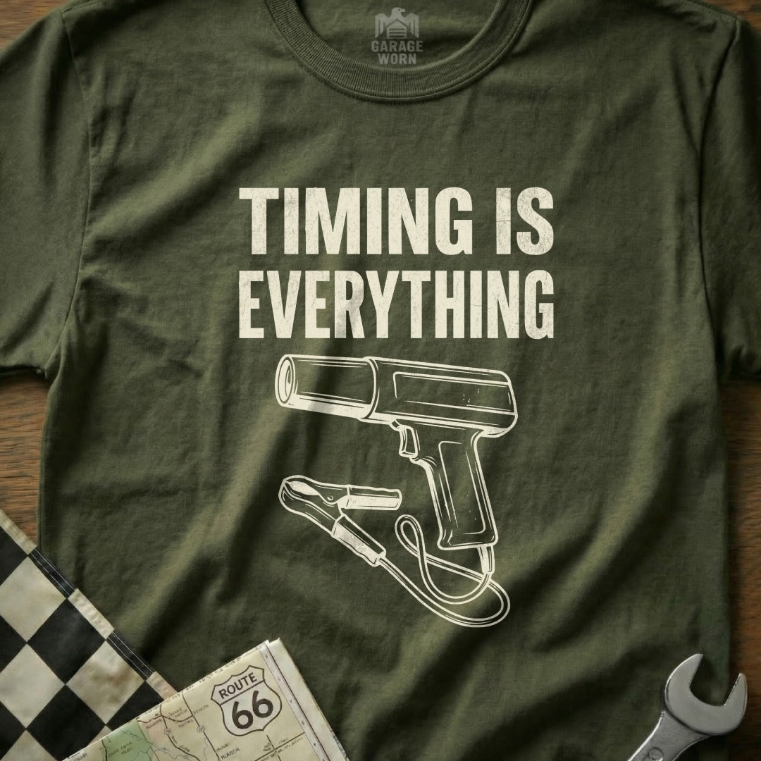 Olive green t-shirt with "TIMING IS EVERYTHING" and drawing of a timing light.
