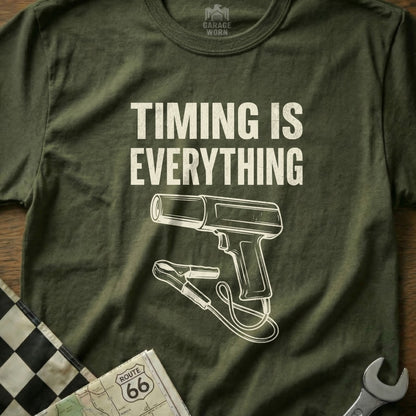 Olive green t-shirt with "TIMING IS EVERYTHING" and drawing of a timing light.
