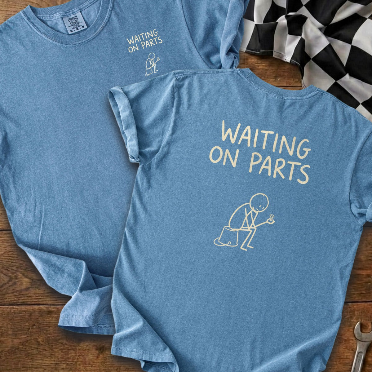 Blue t-shirt with "WAITING ON PARTS" text and a stick figure holding a bolt.
