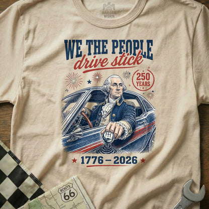 George Washington in car with manual gear shift, "We The People Drive Stick" text.