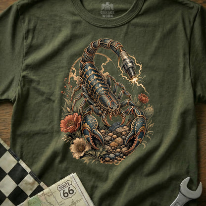Scorpion with spark plug tail and floral elements on a green t-shirt.