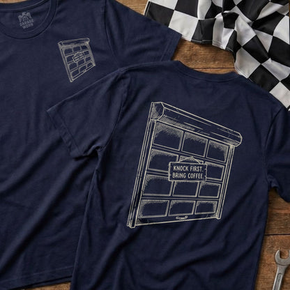 Navy t-shirt with a garage door graphic and "KNOCK FIRST. BRING COFFEE." text.