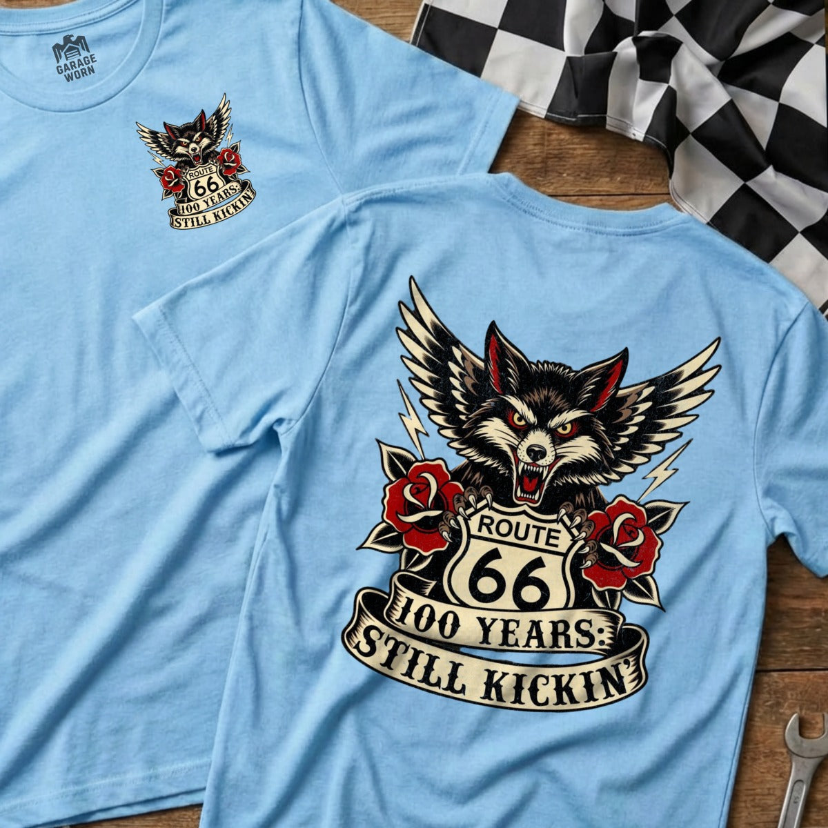 Light blue t-shirts with Route 66 wolf graphic and text "100 Years: Still Kickin'".
