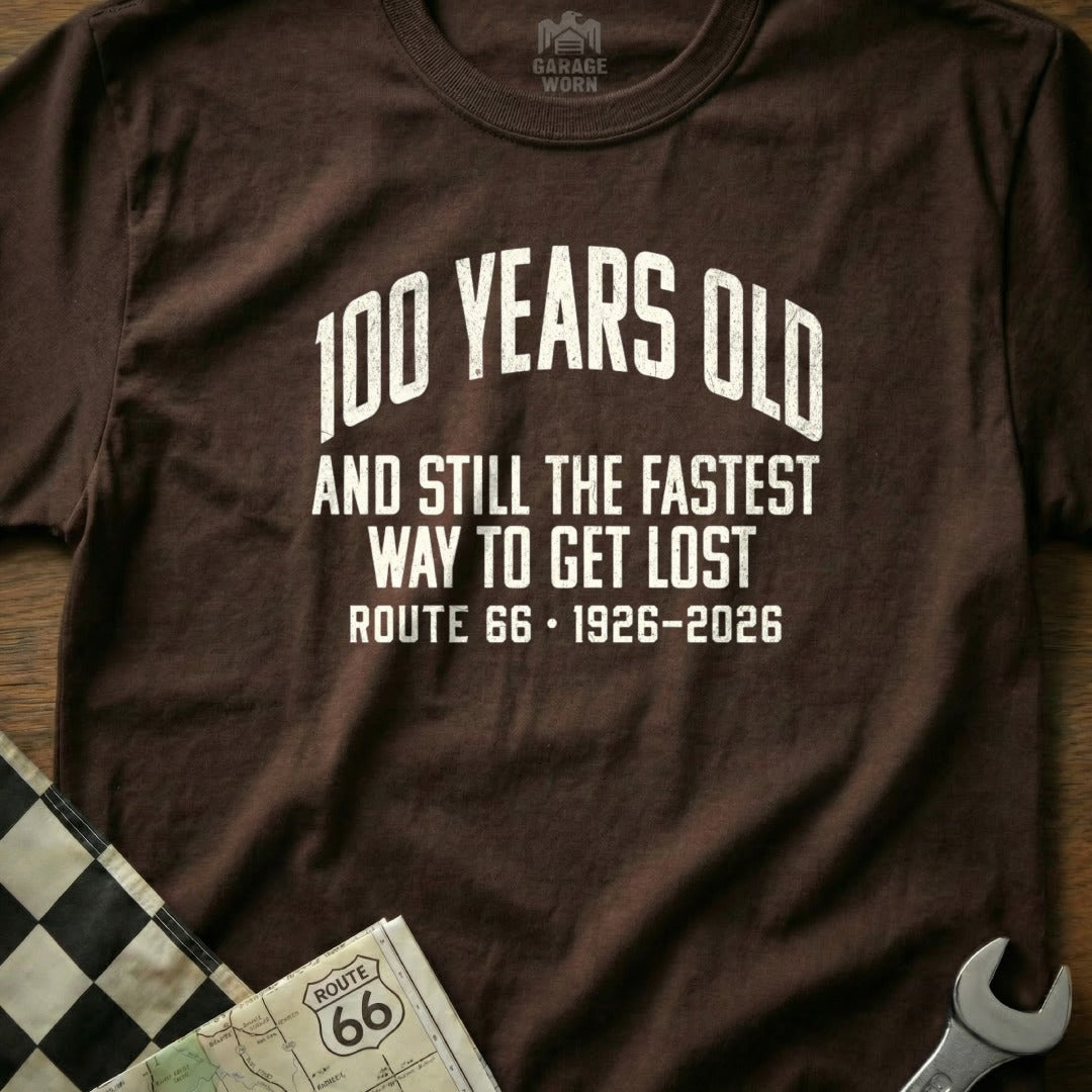 Brown t-shirt with "100 Years Old and Still The Fastest Way To Get Lost Route 66 1926-2026" text.