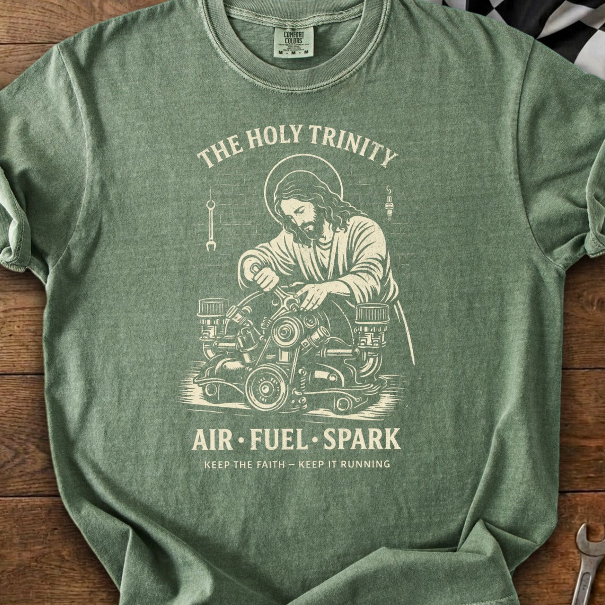 Jesus working on an engine with text "The Holy Trinity Air Fuel Spark".