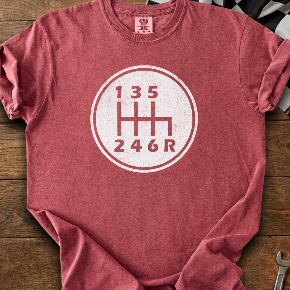 Red t-shirt with a white graphic of a six-speed manual transmission shift pattern.