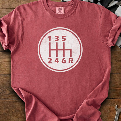 Red t-shirt with a white graphic of a six-speed manual transmission shift pattern.