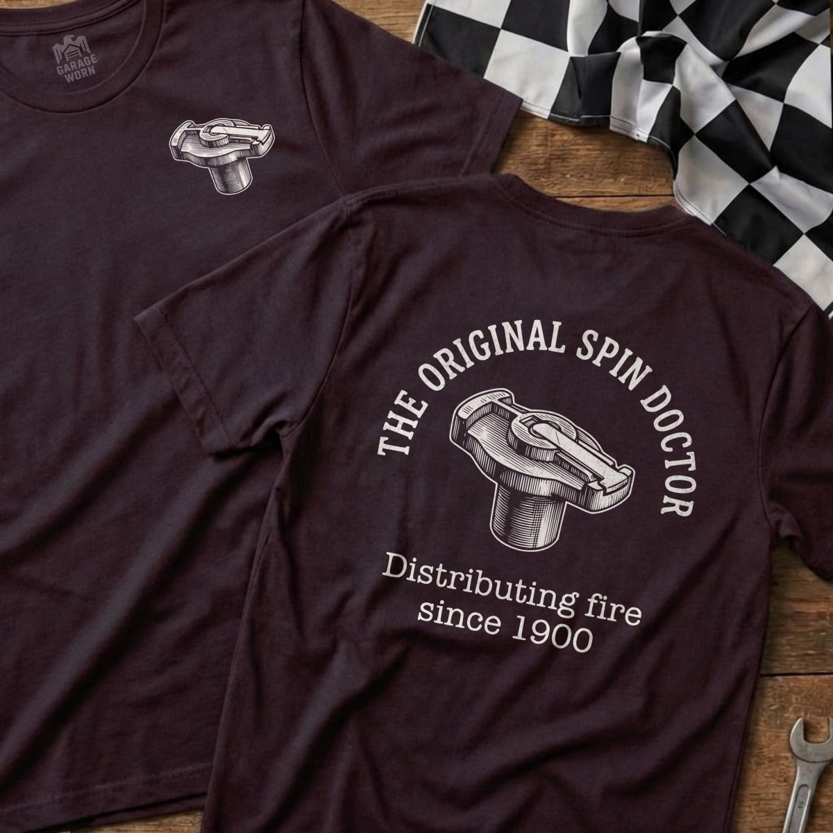 Maroon t-shirt featuring "The Original Spin Doctor" distributing fire since 1900.