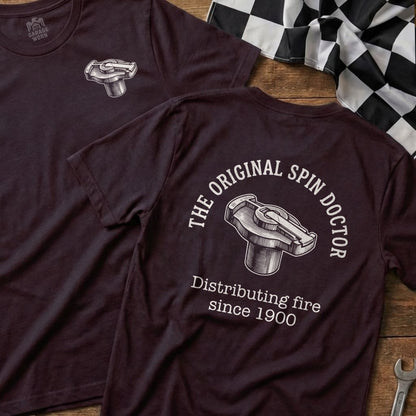 Maroon t-shirt featuring "The Original Spin Doctor" distributing fire since 1900.