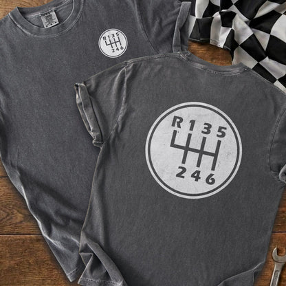 Dark gray t-shirt with a white manual gear shift pattern and "R135" and "246" text.