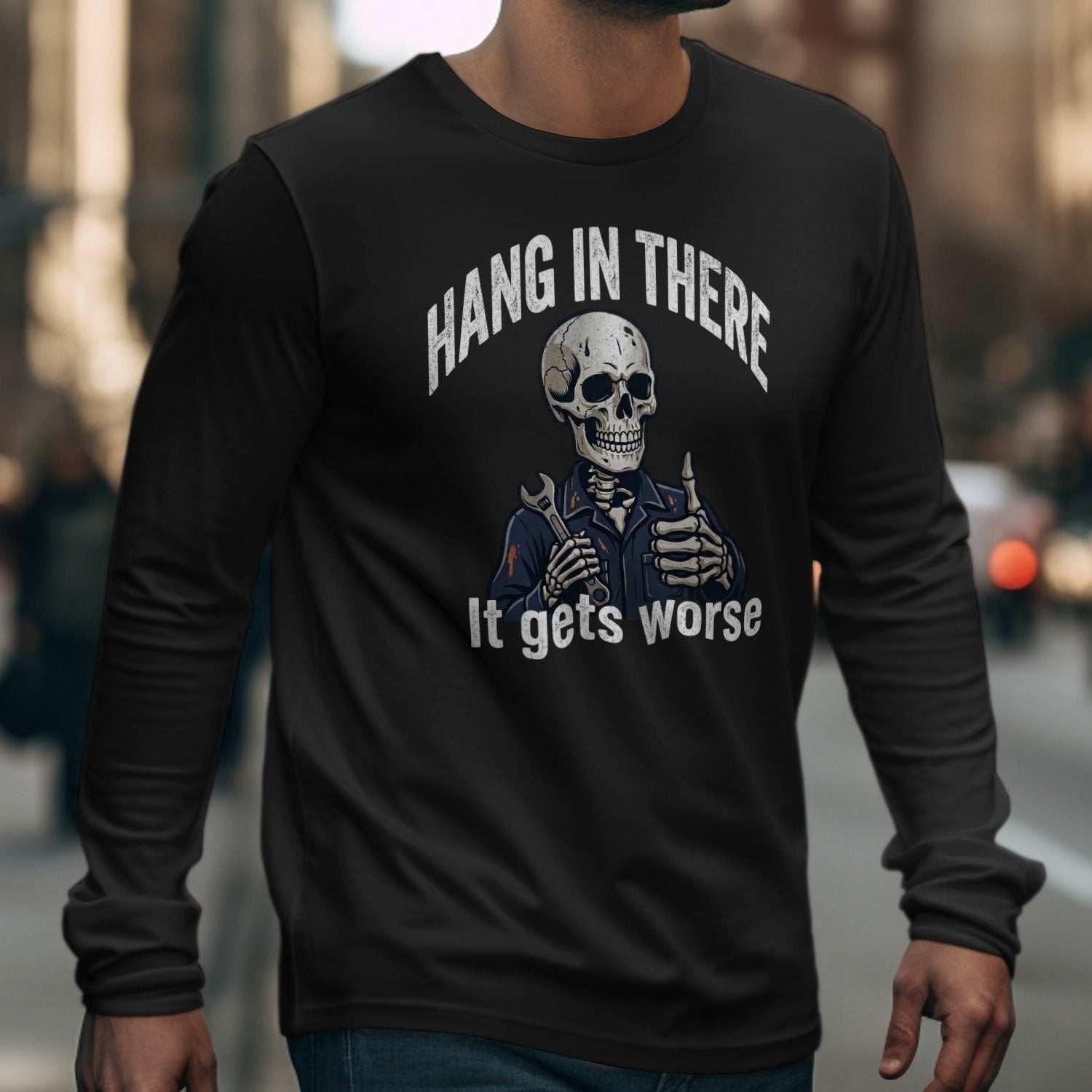 Black long sleeve shirt with skeleton graphic: "Hang in there" and "It gets worse".