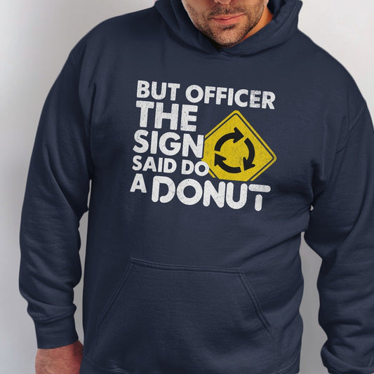 Navy hoodie with white text and yellow roundabout sign: "But officer, the sign said do a donut."