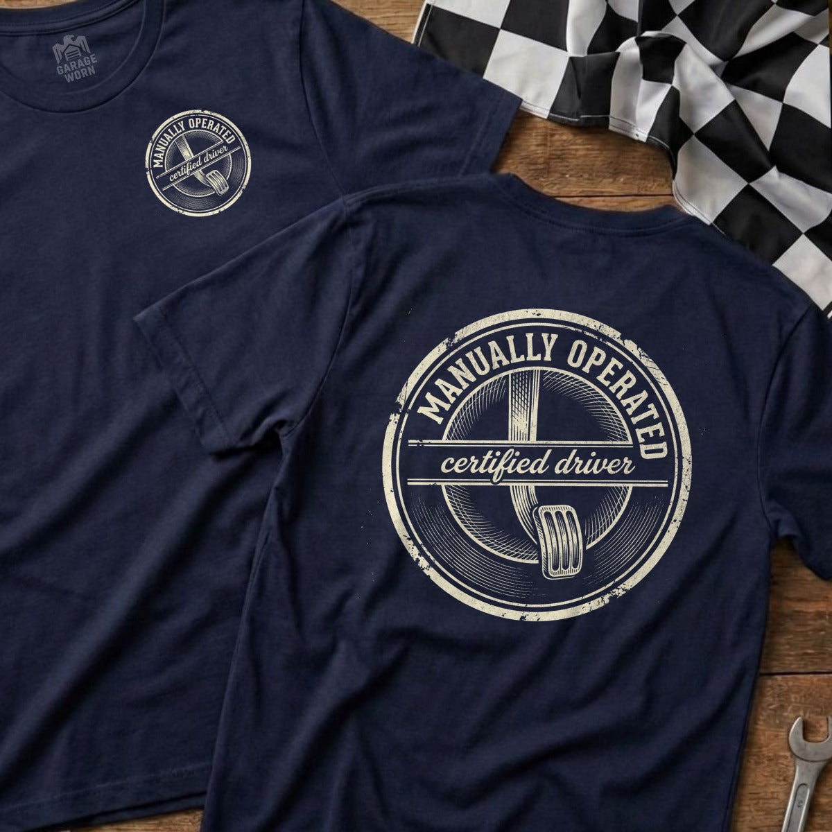 Navy t-shirt with "Manually Operated Certified Driver" graphic featuring a gear shift.