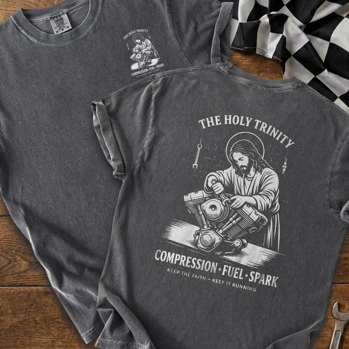 Gray t-shirt with "The Holy Trinity" graphic of Jesus working on a motorcycle engine.