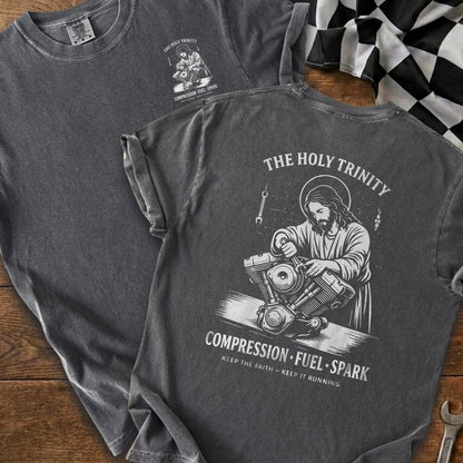 Gray t-shirt with "The Holy Trinity" graphic of Jesus working on a motorcycle engine.