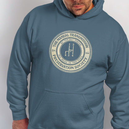 Blue hoodie with "The Manual Transmission Preservation Society" logo featuring a gear shift.
