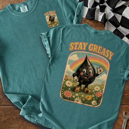 Teal t-shirt with a graphic of a smiling oil drop character and rainbow saying "STAY GREASY".