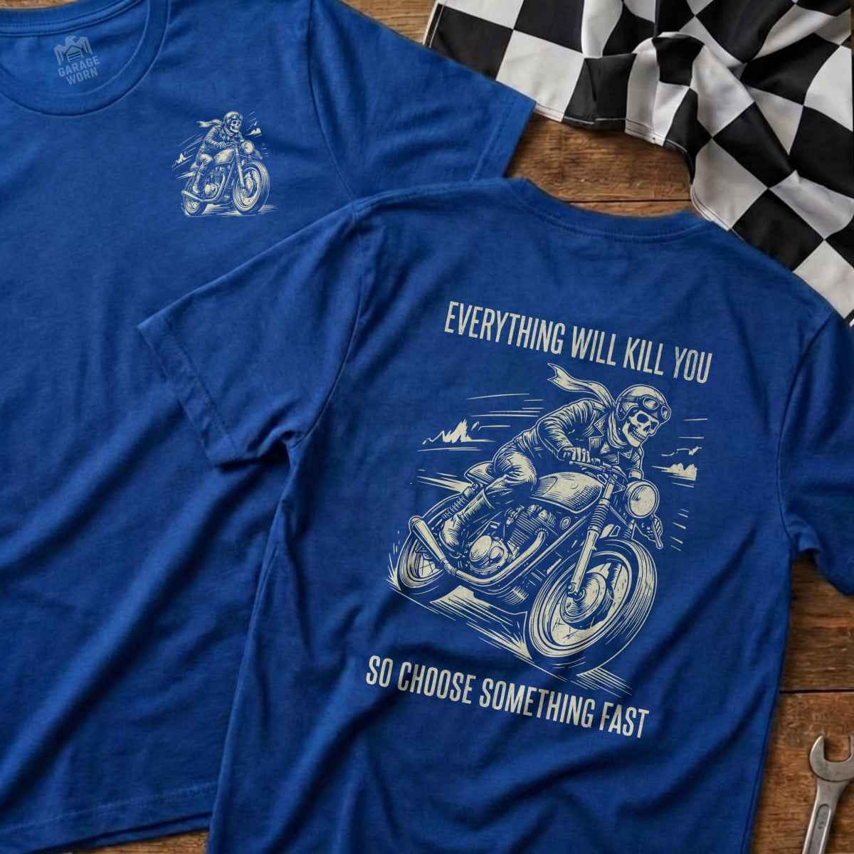 Blue t-shirt with skull on motorcycle graphic and "Everything Will Kill You. So Choose Something Fast." text.