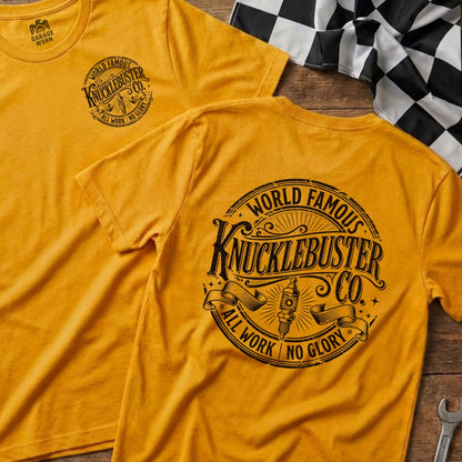 Yellow t-shirt with "World Famous Knucklebuster" logo on back.