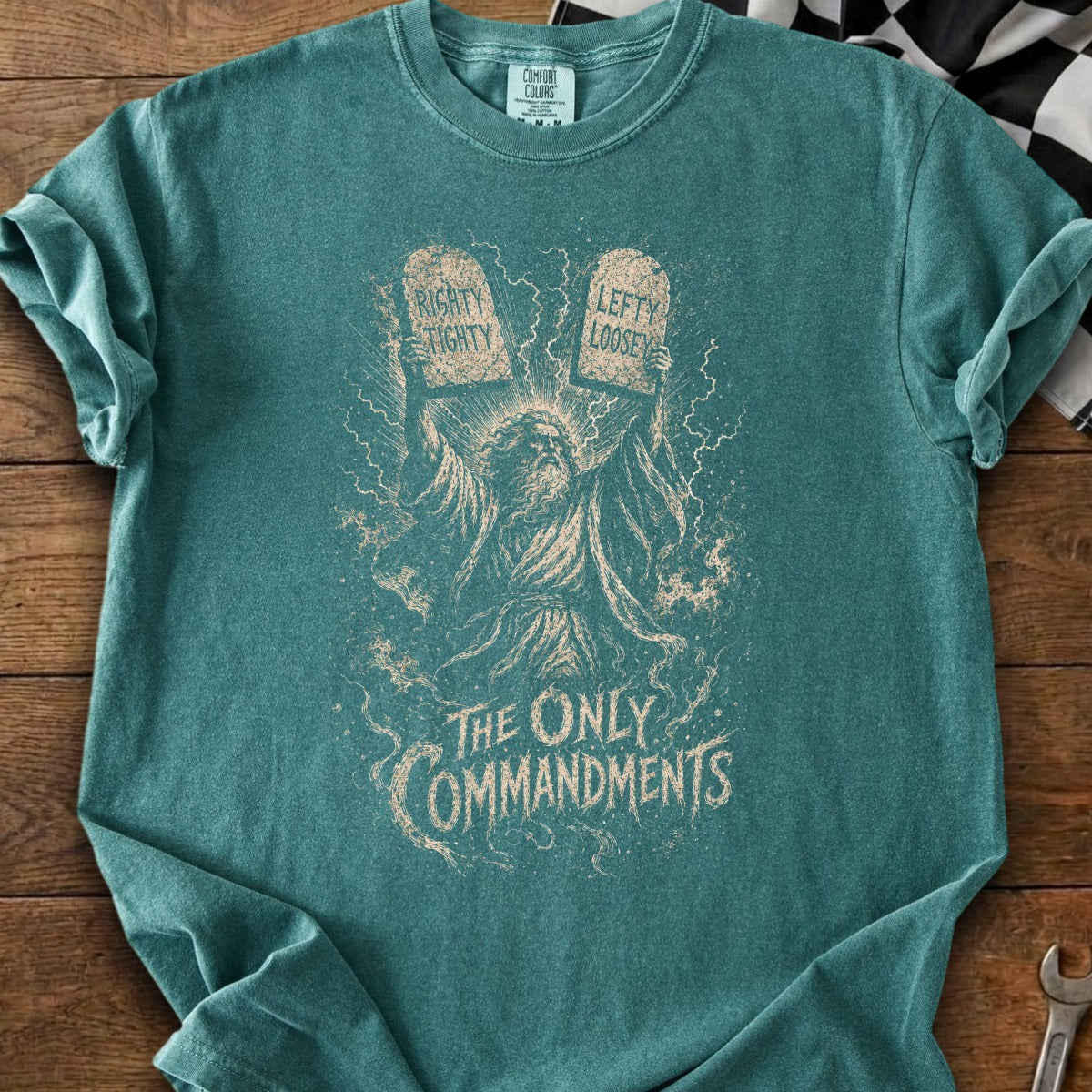 T-shirt with illustration of Moses holding tablets that read "Righty Tight" and "Lefty Loosey."