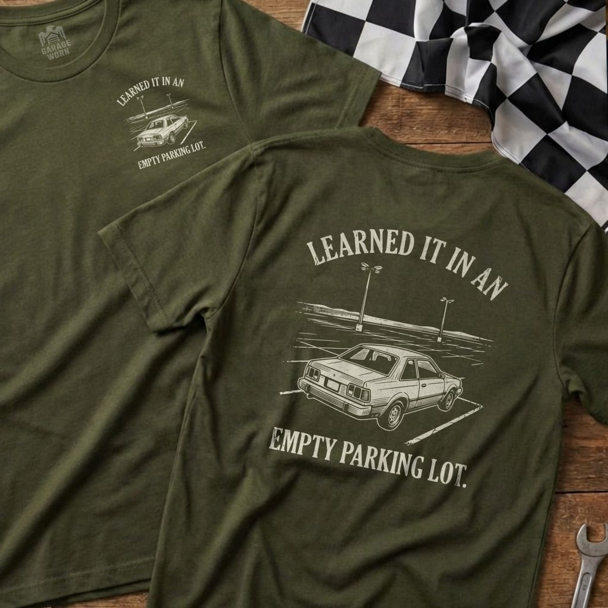 Olive green t-shirts with a car graphic and text "LEARNED IT IN AN EMPTY PARKING LOT."