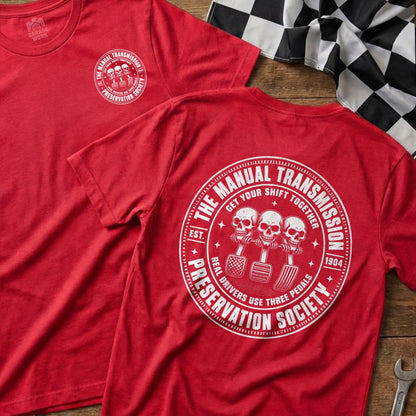 Red t-shirt with "Manual Transmission Preservation Society" graphic featuring three skulls on pedals.