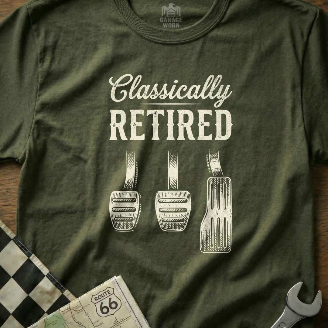 Olive t-shirt with "CLASSICALLY RETIRED" above three car pedals.