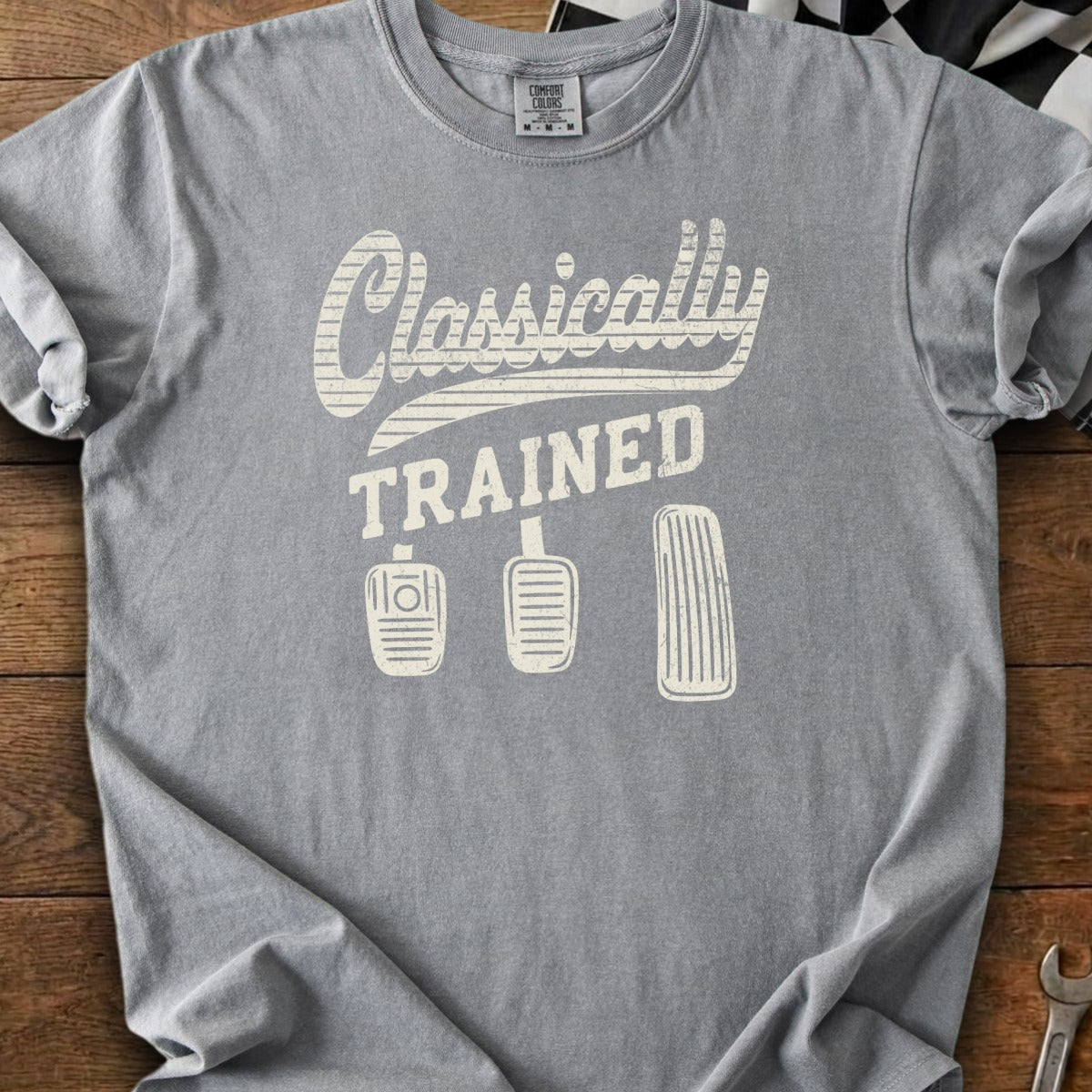 Gray t-shirt with "Classically TRAINED" text and three car pedals.