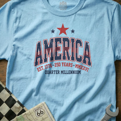 Light blue t-shirt with "America Est. 1776 250 Years Quarter Millennium" text.