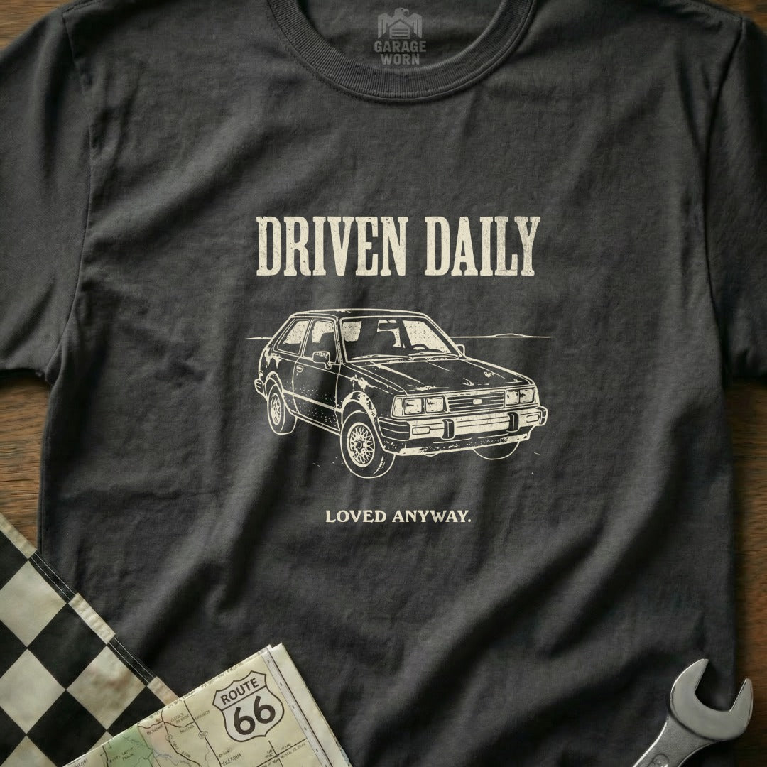 T-shirt with "Driven Daily" and a car illustration.