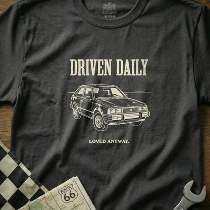 T-shirt with "Driven Daily" and a car illustration.