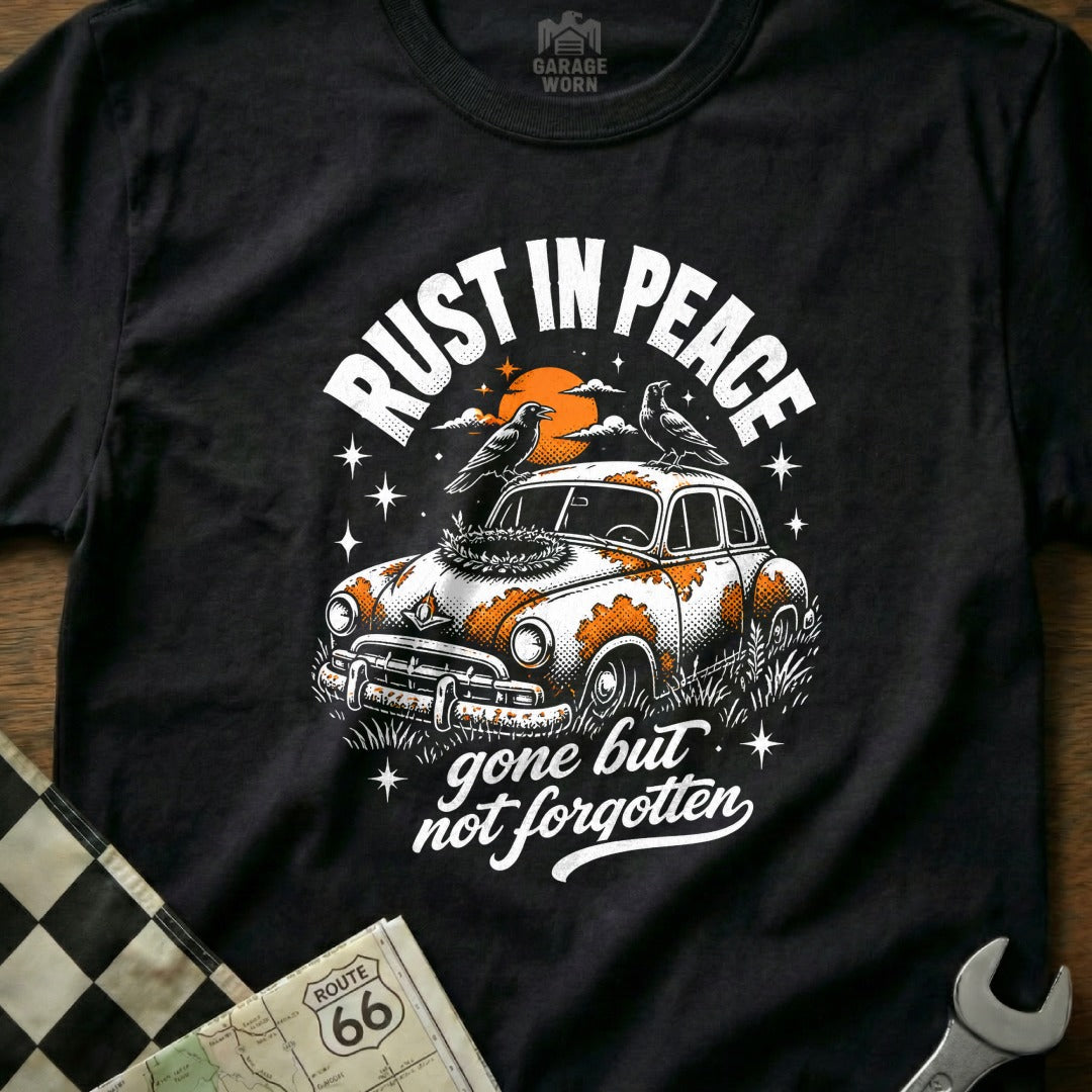 Black t-shirt graphic: RUST IN PEACE, retro car, two crows, sunset, gone but not forgotten.