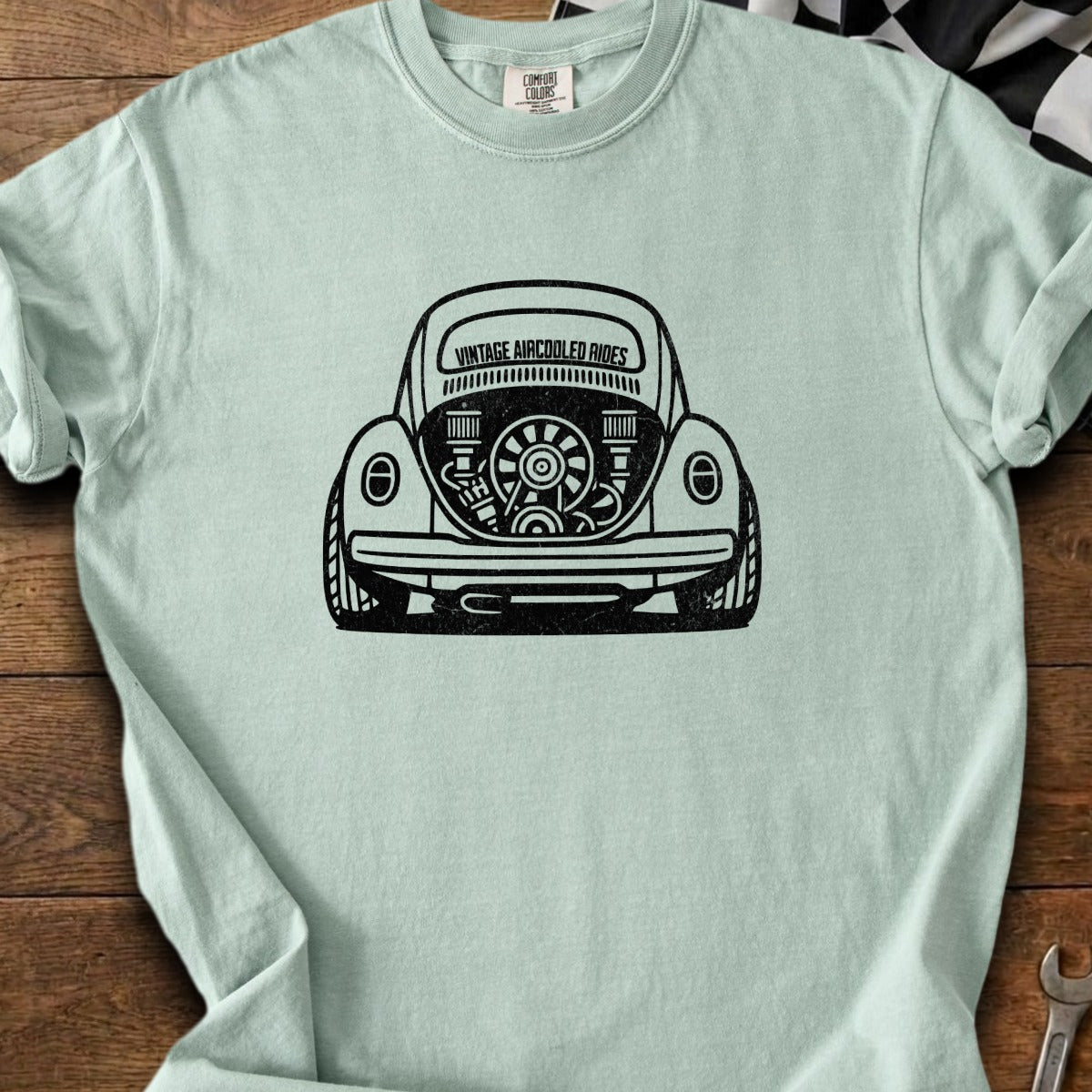 Light blue t-shirt with black graphic of a vintage VW Beetle engine.