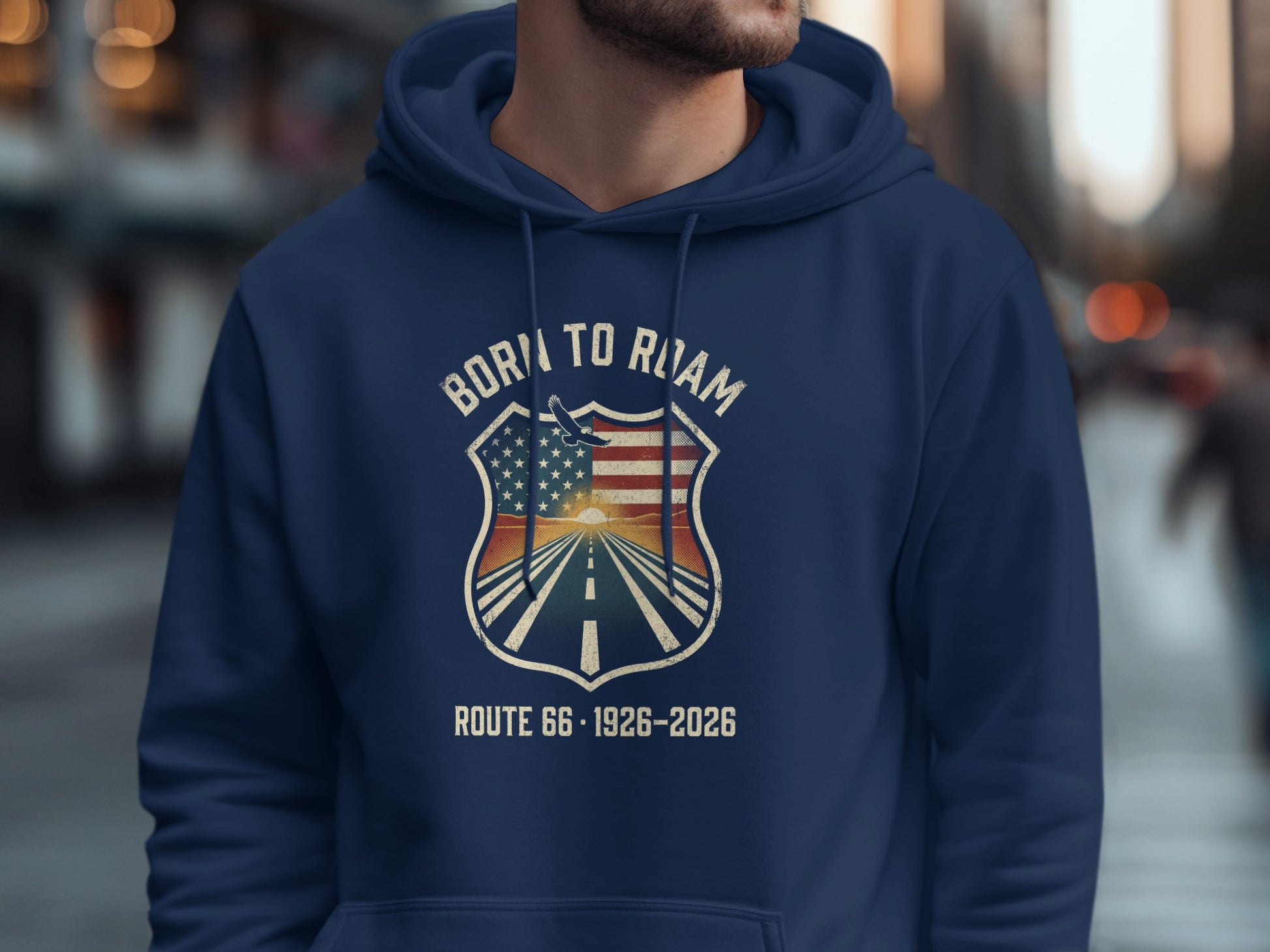 Navy hoodie with "BORN TO ROAM ROUTE 66 1926-2026" crest on chest.