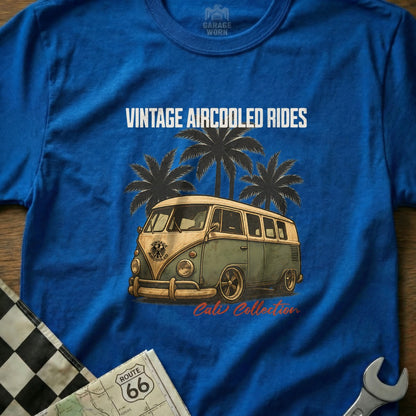 Blue t-shirt with graphic of vintage green and white van, palm trees, and text.