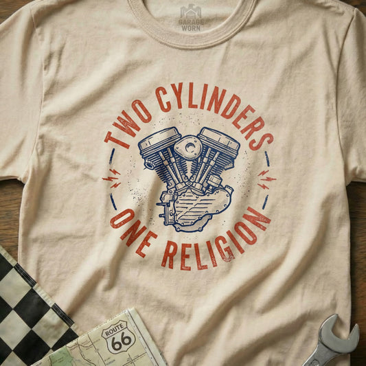 Cream t-shirt with "TWO CYLINDERS ONE RELIGION" and V-twin engine graphic.
