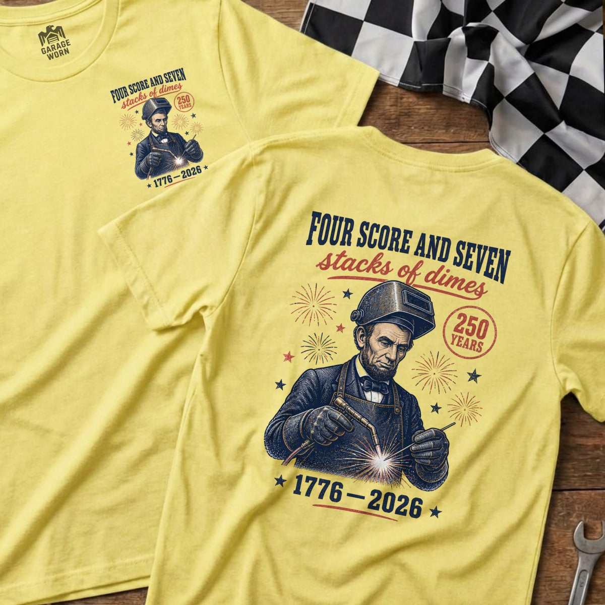 Yellow t-shirts with Abraham Lincoln welding and text "Four score and seven stacks of dimes".