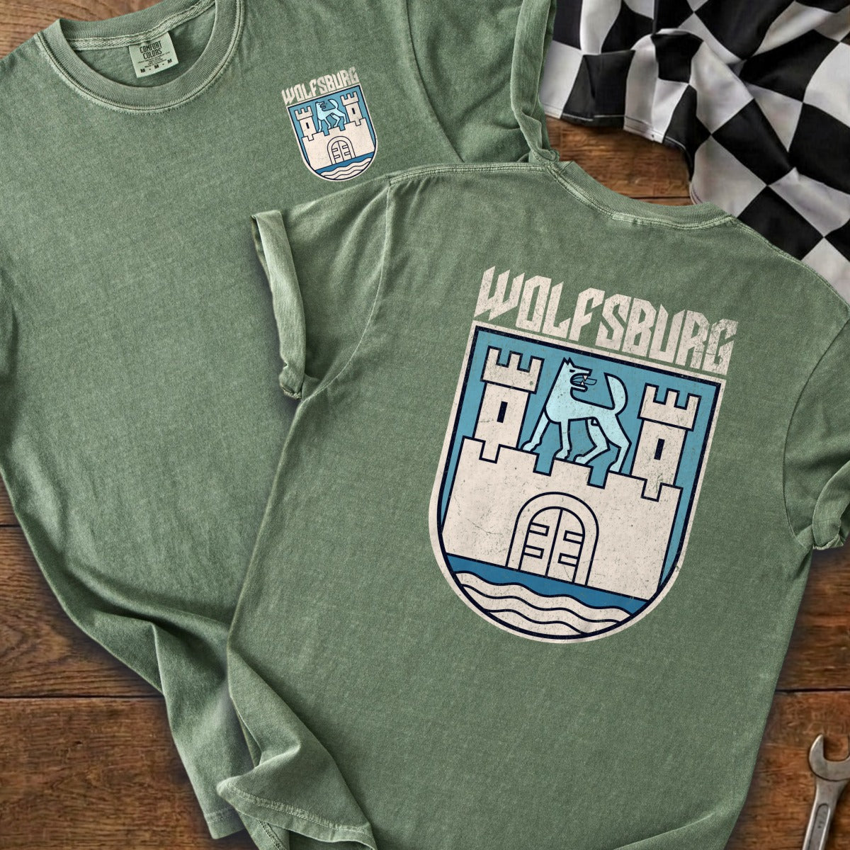 Green t-shirts displayed with "Wolfsburg" text and a crest featuring a castle and wolf.