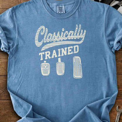 Blue t-shirt with "Classically TRAINED" text and three car pedals.