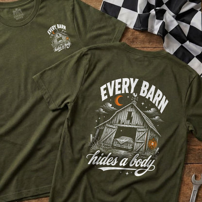 Olive green t-shirt with a barn, car, and text "EVERY BARN hides a body".
