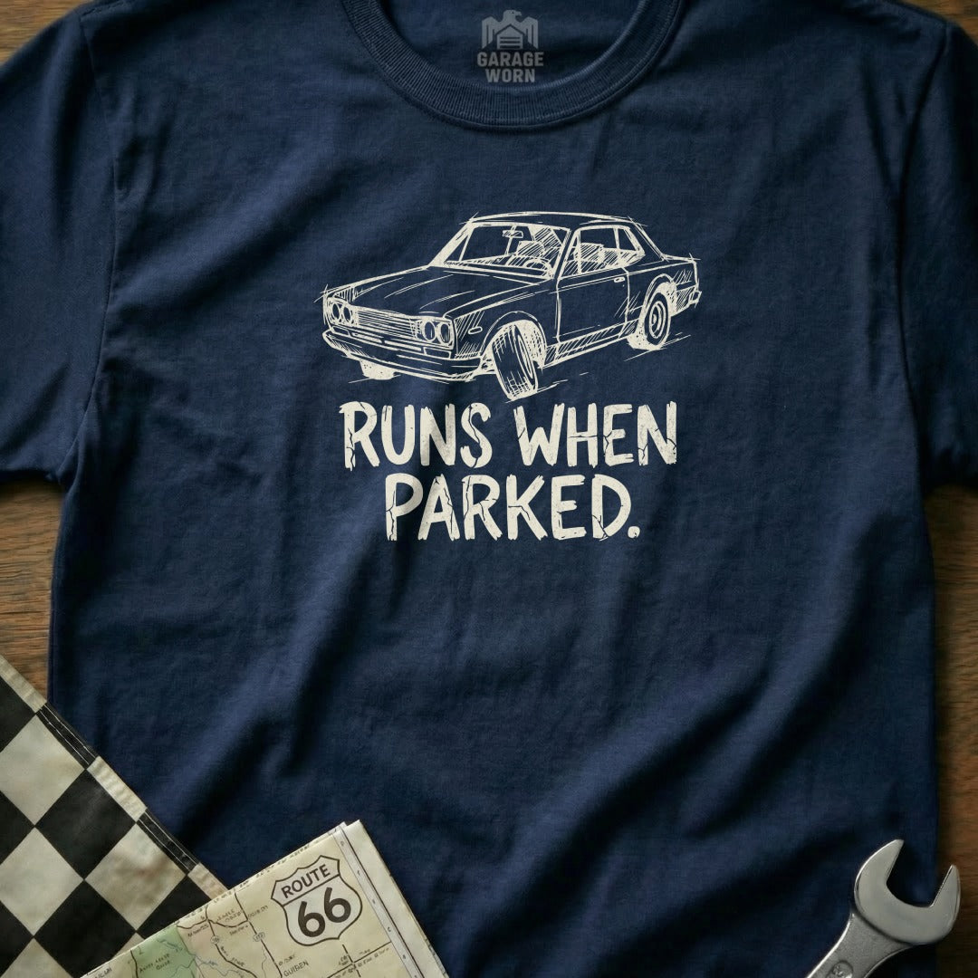 Navy t-shirt with white illustration of a classic car and text "RUNS WHEN PARKED."