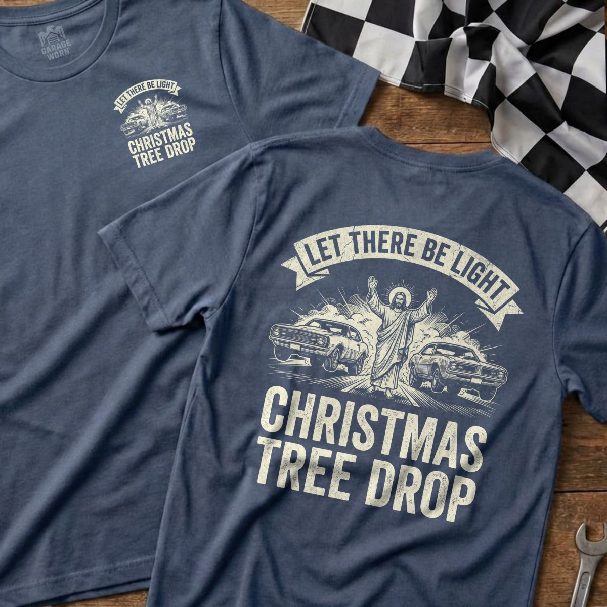 T-shirt with "Let There Be Light Christmas Tree Drop" and Jesus between two cars.