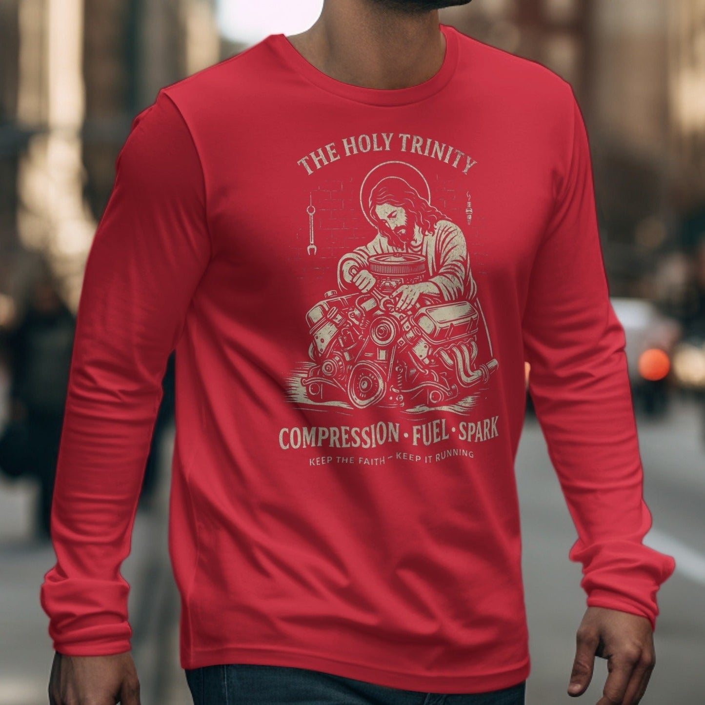 Red long-sleeve shirt with graphic of Jesus working on an engine.