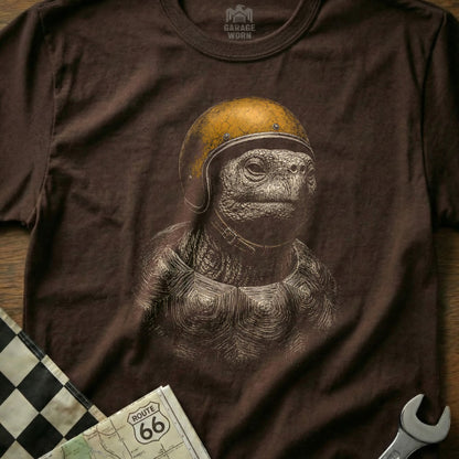 Brown t-shirt with white line art of a tortoise wearing a yellow helmet.
