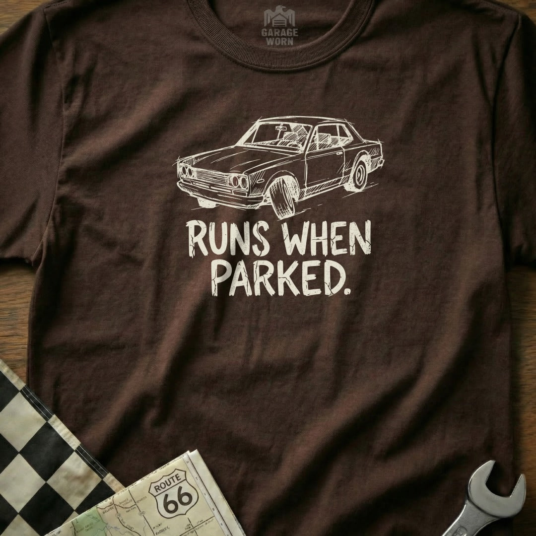 Brown t-shirt with "RUNS WHEN PARKED" and a car graphic.