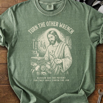 Jesus in a garage holding a wrench, with text "Turn the Other Wrench".